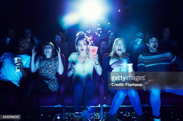 audience enjoying movie at the cinema - scary - fotografias e filmes do acervo