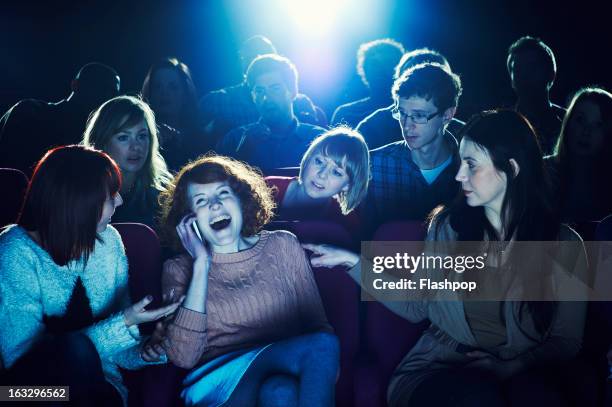 woman using phone during movie at cinema - boom for real stock pictures, royalty-free photos & images