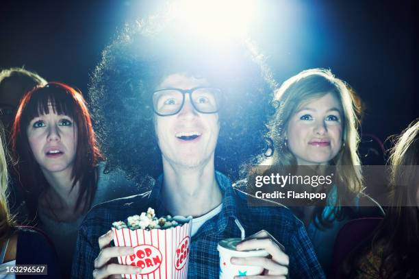 man enjoying movie at cinema - inconvenience stock pictures, royalty-free photos & images