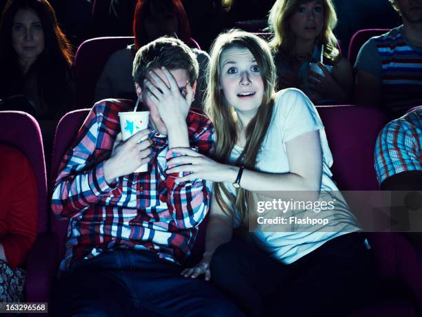 couple enjoying a movie at the cinema - her 2013 film foto e immagini stock