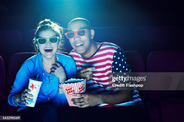 friends at the cinema wearing 3d glasses - nightlife stock pictures, royalty-free photos & images