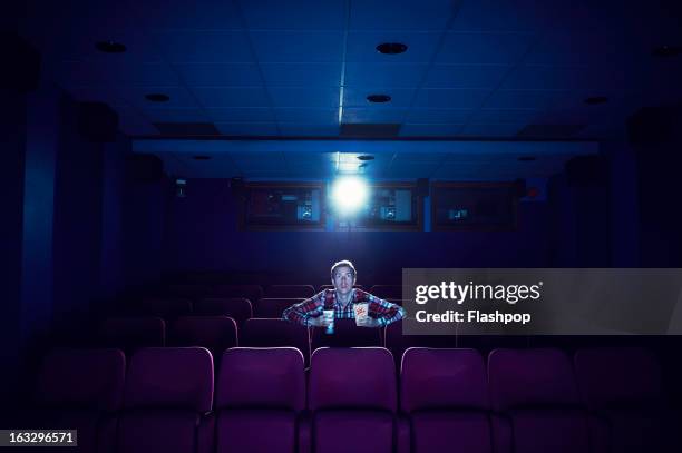 man watching a movie in empty cinema - one film stock pictures, royalty-free photos & images