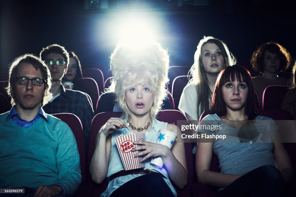 Woman enjoying movie at cinema