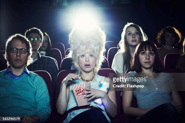 woman enjoying movie at cinema - beehive hair stock pictures, royalty-free photos & images