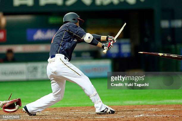 Katsuya Kakunaka of Team Japan breaks his bat during the 2013 World Baseball Classic exhibition game against the Yomiuri Giants at the Fukuoka Yahoo!...