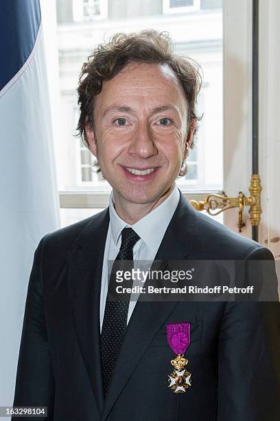 French journalist and author Stephane Bern poses with his insignia after he was appointed officer in the King Leopold order during a ceremony at...