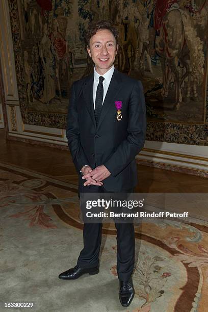 French journalist and author Stephane Bern poses with his insignia after he was appointed officer in the King Leopold order during a ceremony at...