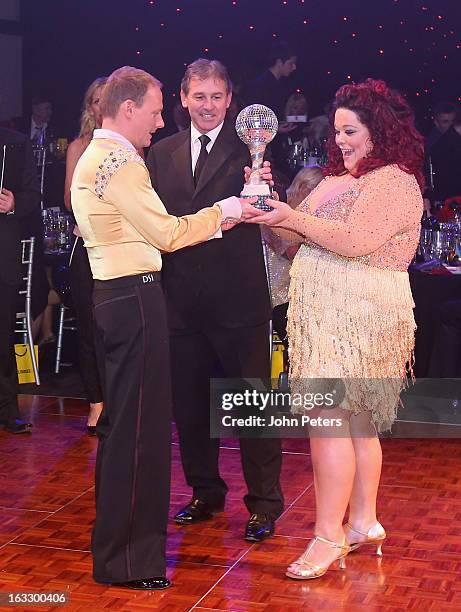 Bryan Robson of Manchester United presents winners Antony Cotton and Lisa Riley with the winners' trophy as part of Dancing with United, in aid of...