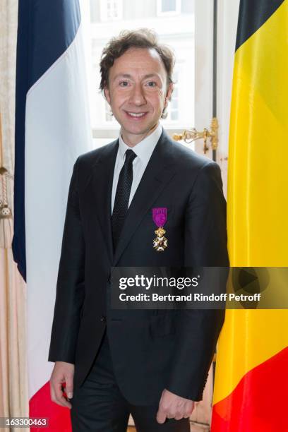 French journalist and author Stephane Bern poses with his insignia after he was appointed officer in the King Leopold order during a ceremony at...