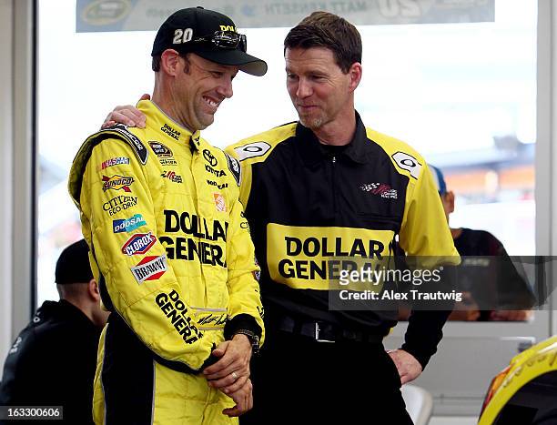 Matt Kenseth, driver of the Dollar General Toyota, speaks with crew chief Jason Ratcliff during NASCAR Sprint Cup Series testing at Las Vegas Motor...