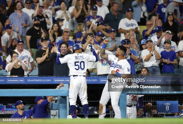 Mookie Betts of the Los Angeles Dodgers is congratulated by David Peralta after a one run home run against the Arizona Diamondbacks during the sixth...