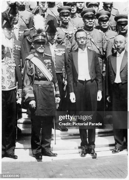 Takashi Hishikari, in full military uniform pays his respect to Mr Henry Pu-Yi in Japan, 1955.