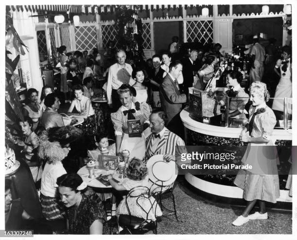On Main Street at Disneyland, a crowd of happy visitors splurge on various different sweet drinks, The Parlor offers yesteryear favorites such as...