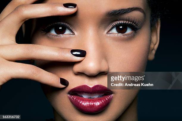 young woman with red lips and black nail polish. - eye make up stockfoto's en -beelden