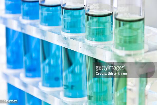 various blue liquids in test tubes - test tube stock pictures, royalty-free photos & images