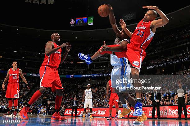 Grant Hill of the Los Angeles Clippers and Kenneth Faried of the Denver Nuggets collide as they vie for a rebound as Lamar Odom of the Los Angeles...