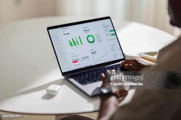 anonymous african american man working from home on his laptop computer (copy space) - omkijken stockfoto's en -beelden