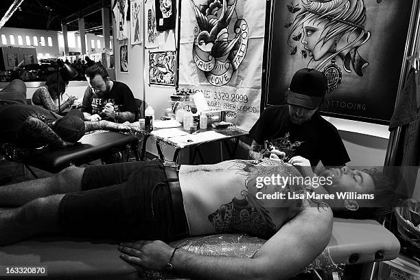 Man is tattooed during The Australian Tattoo & Body Art Expo at the Royal Hall of Industries, Moore Park on March 8, 2013 in Sydney, Australia. The...