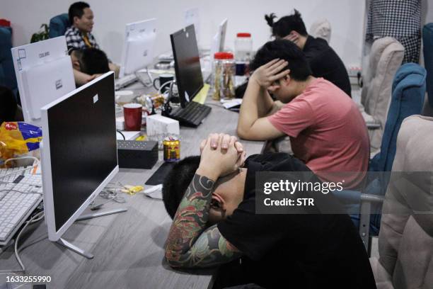 This picture taken on August 29, 2023 shows a group of Chinese nationals who were arrested during a police raid on suspicion of running an online...