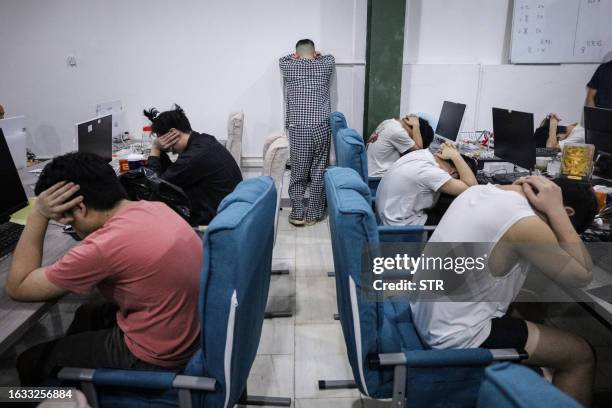 This picture taken on August 29, 2023 shows a group of Chinese nationals who were arrested during a police raid on suspicion of running an online...