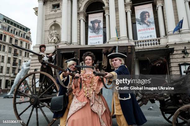 Actors wearing clothes from “Dovbush” movie hold flintlock pistols and rifles during performance near Lviv Theatre of Opera and Ballet to present the...