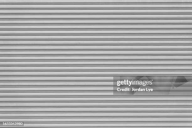 close-up of a metallic rolling shutter - shop shutter stock pictures, royalty-free photos & images