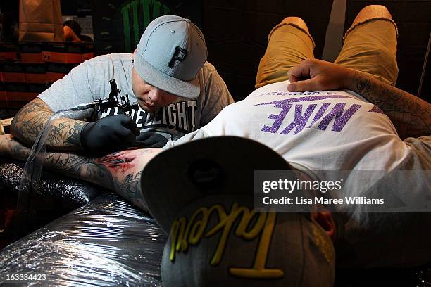 Man is tattooed during The Australian Tattoo & Body Art Expo at the Royal Hall of Industries, Moore Park on March 8, 2013 in Sydney, Australia. The...