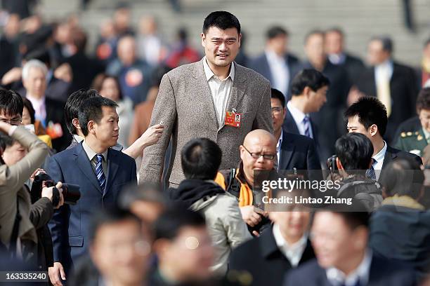 Delegate Yao Ming, former NBA basketball star, walks out the Great Hall of the People after a plenary session of the Chinese People's Political...