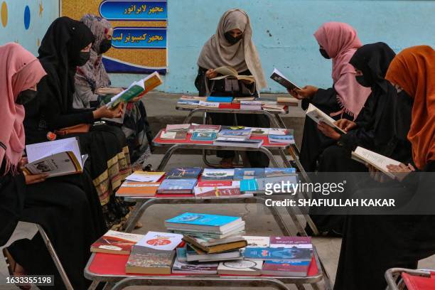 Afghan girls read at a library in Jalalabad on Agust 30, 2023.