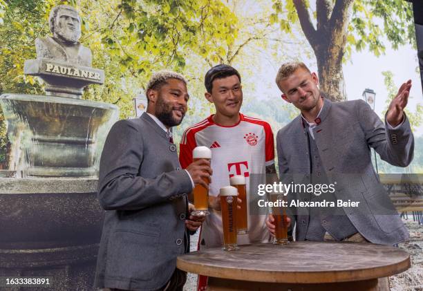 Serge Gnabry, Minjae Kim and Matthijs de Ligt of FC Bayern Muenchen pose during the photo session of FC Bayern Muenchen partner Paulaner on August...