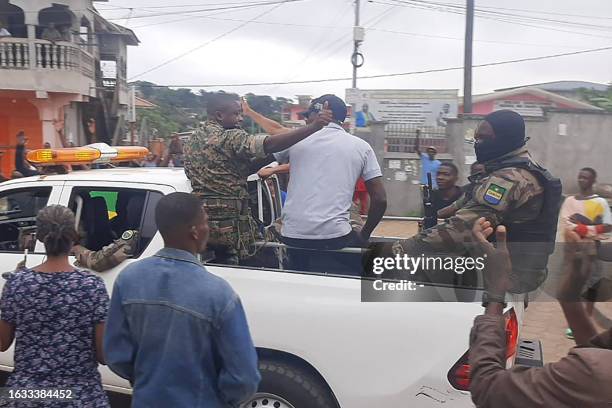 Residents applaud members of the security forces in the Plein Ciel district Libreville on August 30, 2023 after a group of Gabonese military officers...