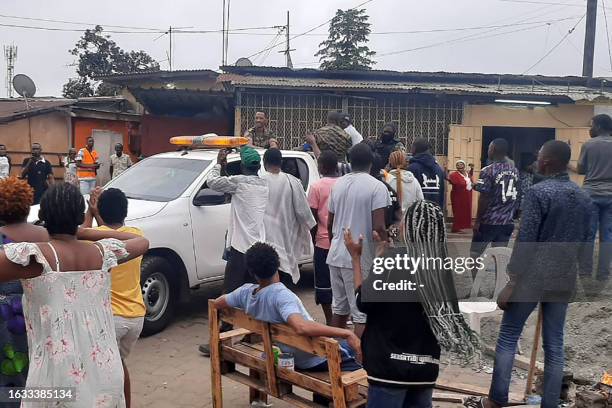 Residents applaud members of the security forces in the Plein Ciel district Libreville on August 30, 2023 after a group of Gabonese military officers...