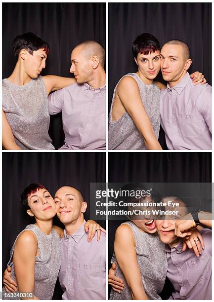 young couple having fun in photo booth - waist up photos stock-fotos und bilder