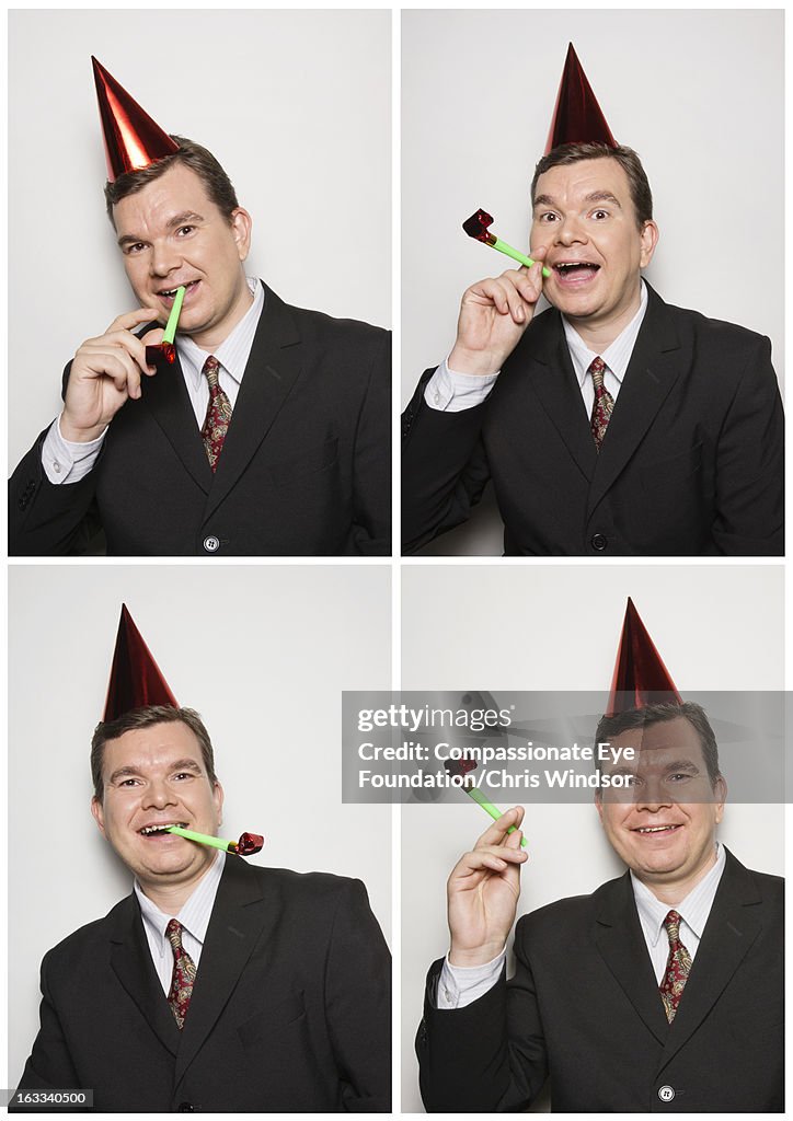 Businessman in photo booth wearing party hat