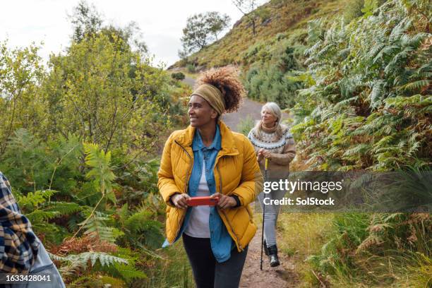 ladies hiking together - walking stock pictures, royalty-free photos & images