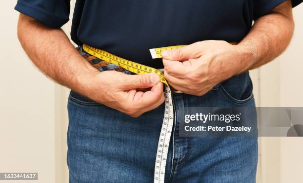 senior man with measuring tape - dieting stock pictures, royalty-free photos & images