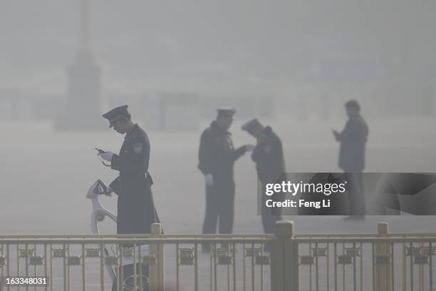 Policemen guard at the Tiananmen Square as delegates attending a plenary session of the Chinese People's Political Consultative Conference during...