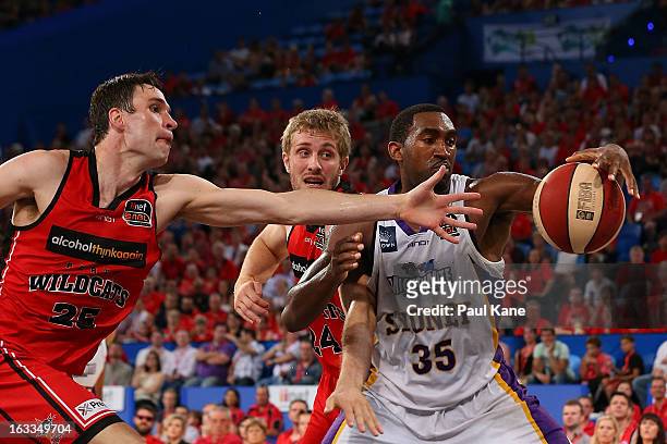 Darnell Lazare of the Kings gathers the ball against Jeremiah Trueman and Jesse Wagstaff of the Wildcats during the round 22 NBL match between the...