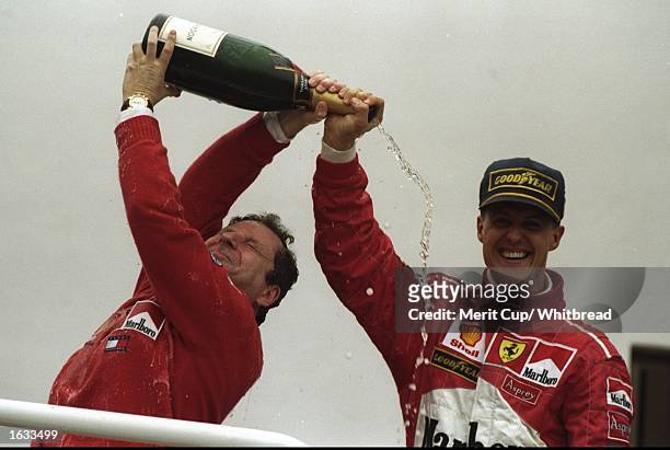 Michael Schumacher and Jean Todt celebrate with the champagne after the 1998 Argentinian Grand Prix, held in Buenos Aires, Argentina. Michael...