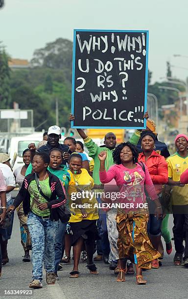 Protesters march outside the Benoni court on March 8 calling for no bail for the police officers charged with murdering Mido Macia, a Mozambican taxi...