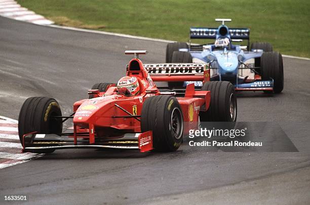 Eddie Irvine of Ireland and Ferrari leads a Benetton round a corner during the 1998 Argentinian Grand Prix, held in Buenos Aires, Argentina. Michael...
