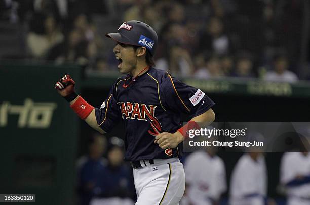 Yuichi Honda of Japan reacts after scoring in the eighth inning during the World Baseball Classic Second Round Pool 1 game between Japan and Chinese...