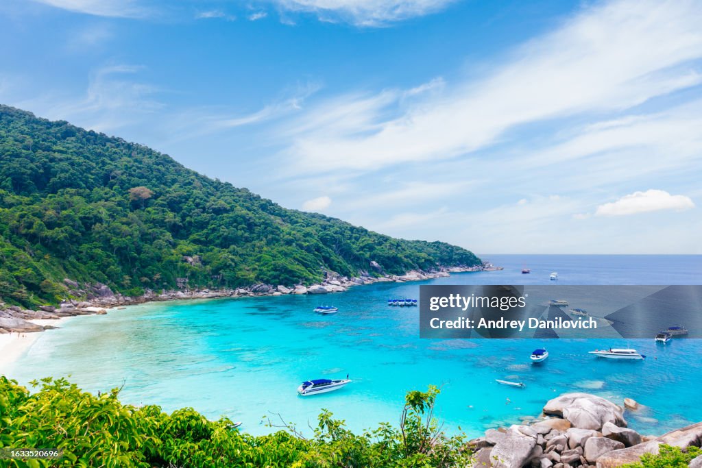 Tropical beach with clear blue water and mountainous background on Similan islands in Thailand. Aerial view.