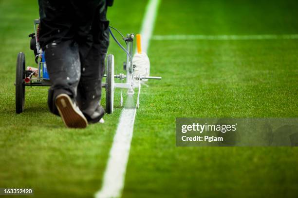 painting grass turf lines on a sports field - sportveld onderhouder stockfoto's en -beelden