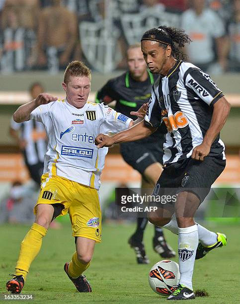 Brazil´s Atletico Mineiro player Ronaldhino is marked by Bolivia´s The Strongest player Alejandro Chumacero during their 2013 Copa Libertadores...