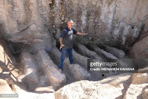 An Israel Antiquities Authority archaeologist shows an ancient channel installation discovered in the City of David National Park in Jerusalem on...