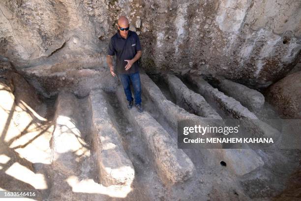 An Israel Antiquities Authority archaeologist shows an ancient channel installation discovered in the City of David National Park in Jerusalem, on...