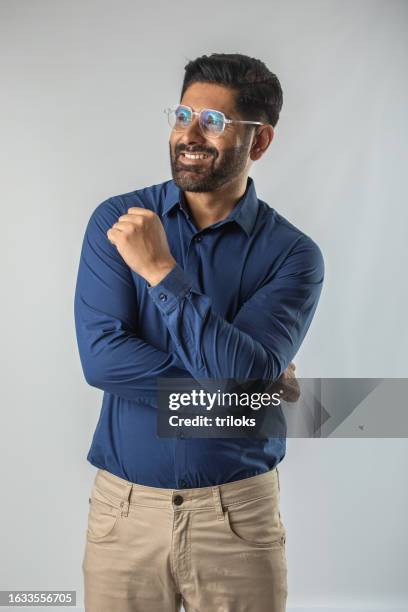 portrait of handsome mid adult man smiling while standing isolated against white background - man look side stock pictures, royalty-free photos & images