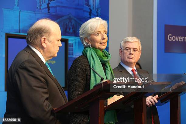 In this handout image provided by Justin MacInnes, International Monetary Fund Managing Director Christine Lagarde with Minister for Finance, Michael...