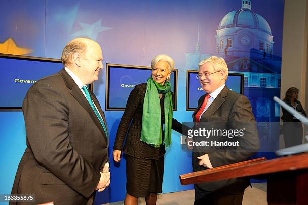In this handout image provided by Justin MacInnes, International Monetary Fund Managing Director Christine Lagarde with Minister for Finance, Michael...